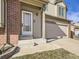 White front door with sidelights and concrete steps leading to entry at 9125 Bell Flower Way, Highlands Ranch, CO 80126