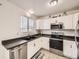 Modern kitchen with stainless steel appliances and white cabinets at 9125 Bell Flower Way, Highlands Ranch, CO 80126