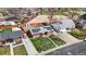 Aerial view of a red brick home with solar panels in a residential area with mature trees and a nearby park at 3341 W 94Th Ave, Westminster, CO 80031