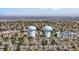 Expansive aerial view showcasing a city with water towers amid residential houses and trees at 3341 W 94Th Ave, Westminster, CO 80031