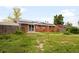 Backyard with a brick house, fencing, and solar panels on the roof of the home at 3341 W 94Th Ave, Westminster, CO 80031