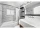 Updated bathroom with subway tile, black shelving, and a classic sink with a medicine cabinet at 3341 W 94Th Ave, Westminster, CO 80031