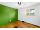 Bright bedroom featuring hardwood floors, a white ceiling fan, and a window overlooking the neighborhood at 3341 W 94Th Ave, Westminster, CO 80031