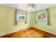 Sunny bedroom with hardwood floors, two windows, and neutral-colored walls at 3341 W 94Th Ave, Westminster, CO 80031