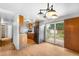 Open concept kitchen features wood cabinets, black appliances, and sliding doors to the backyard at 3341 W 94Th Ave, Westminster, CO 80031