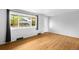 Well-lit living room features hardwood floors and a large window with views of the front yard and neighborhood at 3341 W 94Th Ave, Westminster, CO 80031