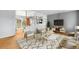 Bright living room featuring hardwood floors, stylish furniture and a modern entertainment center at 3341 W 94Th Ave, Westminster, CO 80031