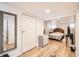 Basement bedroom featuring a bed, dresser, mirror and closet at 4354 Chase St, Denver, CO 80212