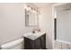 Bathroom featuring a dark vanity, tiled floor, and ample lighting at 4354 Chase St, Denver, CO 80212