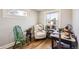 Comfortable sitting room with hardwood floors, a cozy chair, plants, and a bright window at 4354 Chase St, Denver, CO 80212