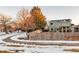 Backyard of a home with a wooden fence, deck, and snowy ground at 13363 Cherry Ct, Thornton, CO 80241