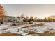 View of a home's backyard with a wooden fence and a snowy pathway at 13363 Cherry Ct, Thornton, CO 80241