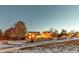 Night view of home's backyard, showcasing a fenced area and snowy landscape at 13363 Cherry Ct, Thornton, CO 80241