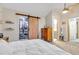 Main bedroom with barn door leading to the ensuite bathroom and closet at 13363 Cherry Ct, Thornton, CO 80241