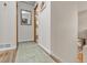 Light and bright hallway with wood flooring and neutral wall tones at 13363 Cherry Ct, Thornton, CO 80241