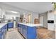 Modern kitchen with blue island, stainless steel appliances, and white cabinets at 13363 Cherry Ct, Thornton, CO 80241