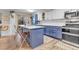 Modern kitchen with blue cabinets, white countertops, and an island at 13363 Cherry Ct, Thornton, CO 80241