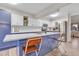 Modern kitchen with blue island, stainless steel appliances, and white cabinets at 13363 Cherry Ct, Thornton, CO 80241