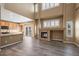 Bright living room with soaring ceilings, fireplace, and an open kitchen concept at 12062 Song Bird Hills St, Parker, CO 80138