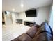 Finished basement with tv, foosball table, and ample space for entertaining at 12566 Dexter St, Thornton, CO 80241