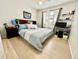 Comfortable bedroom with natural light, ceiling fan, and light wood floors at 12566 Dexter St, Thornton, CO 80241