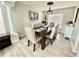 Elegant dining room with a dark wood table, upholstered chairs, decorative chandelier, and stylish decor at 12566 Dexter St, Thornton, CO 80241