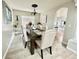 Tasteful dining area with a dark wooden table, upholstered seating, and access to an adjacent kitchen at 12566 Dexter St, Thornton, CO 80241