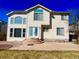 Two-story home with neutral siding, decorative windows, and a spacious patio at 12566 Dexter St, Thornton, CO 80241
