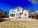 Two-story home with neutral siding, decorative windows, and a spacious patio at 12566 Dexter St, Thornton, CO 80241