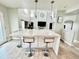 Bright kitchen with a large island, stainless steel appliances, and an open floor plan leading to the living area at 12566 Dexter St, Thornton, CO 80241