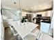 Bright, open kitchen with white cabinets, stainless steel appliances, and a large island with seating at 12566 Dexter St, Thornton, CO 80241