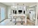Contemporary kitchen with an extended island, stainless steel appliances, and a seamless transition to the living area at 12566 Dexter St, Thornton, CO 80241