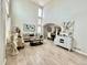 Bright living room features high ceilings, wood floors, and stylish decor at 12566 Dexter St, Thornton, CO 80241