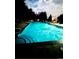Night view of community pool with inviting blue water, surrounded by chairs at 12566 Dexter St, Thornton, CO 80241