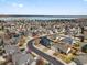 Aerial view of neighborhood and lake with houses and street, showcasing the community's location and landscape at 8346 Vivian St, Arvada, CO 80005