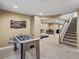 Spacious finished basement with a foosball table and carpet flooring at 8346 Vivian St, Arvada, CO 80005