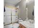 Bathroom with a tiled shower, toilet, and a vanity sink at 8346 Vivian St, Arvada, CO 80005