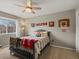 Bright bedroom featuring a ceiling fan, and fun sports decor at 8346 Vivian St, Arvada, CO 80005