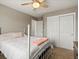 A bedroom featuring a ceiling fan and double door closet at 8346 Vivian St, Arvada, CO 80005