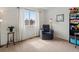 Comfortable bedroom with natural light, chair, and neutral decor at 8346 Vivian St, Arvada, CO 80005