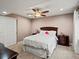 Finished bedroom with ceiling fan, bedside tables and a window at 8346 Vivian St, Arvada, CO 80005