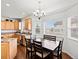 Eat-in dining area featuring hardwood floors, bright windows, and a decorative chandelier at 8346 Vivian St, Arvada, CO 80005