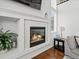 Living room fireplace featuring decorative white mantle with inset lighting at 8346 Vivian St, Arvada, CO 80005