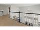 Second story hallway overlooking the first floor and large windows at 8346 Vivian St, Arvada, CO 80005