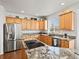 Spacious kitchen featuring modern appliances, island cooktop, and generous counter space at 8346 Vivian St, Arvada, CO 80005
