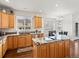 Well-equipped kitchen with wooden cabinets, granite countertops, and modern appliances at 8346 Vivian St, Arvada, CO 80005