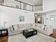 Spacious living room with high ceilings, balcony, and a comfortable sectional sofa at 8346 Vivian St, Arvada, CO 80005