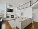 Bright living room with fireplace, built-ins, and large windows at 8346 Vivian St, Arvada, CO 80005