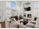 Bright living room with fireplace, built-ins, and large windows at 8346 Vivian St, Arvada, CO 80005
