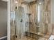 Walk-in shower with a glass door and tile surround at 8346 Vivian St, Arvada, CO 80005